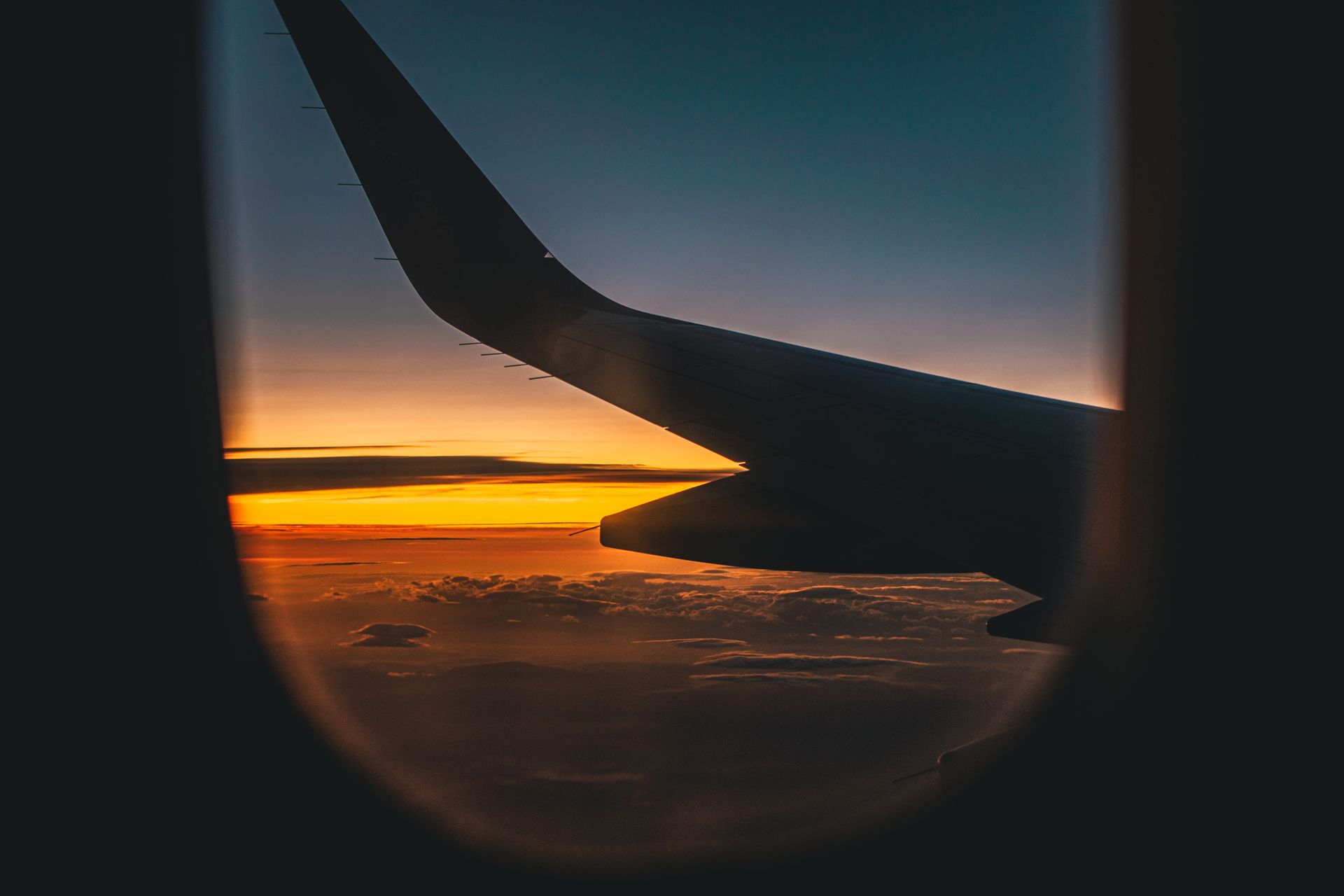 Airplane wing at golden sunset