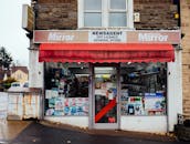 这家带有醒目标牌和红色遮阳篷的经典城市新闻代理店，非常适合展现当地的零售商业风貌