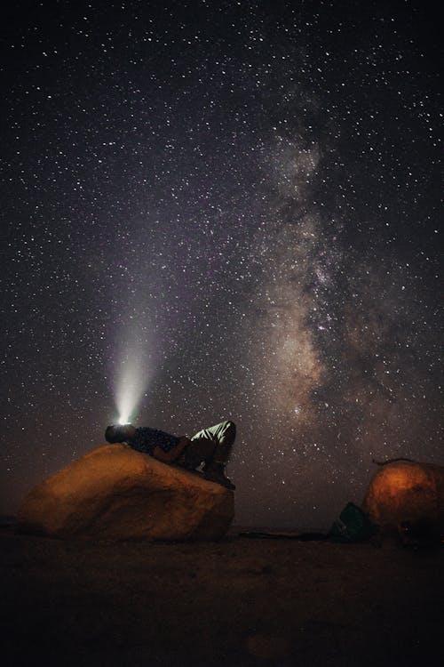 Free Man Lying on Stone Gazing The Milkyway Stock Photo