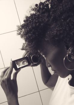 Close-up of a woman's eye captured on a video screen, showcasing unique perspective.