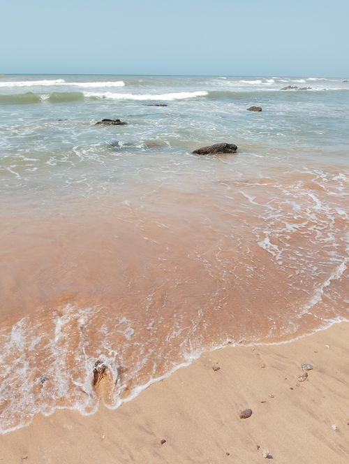 Free Tranquil ocean waves gently washing onto a sandy beach in Casablanca, Morocco. Stock Photo