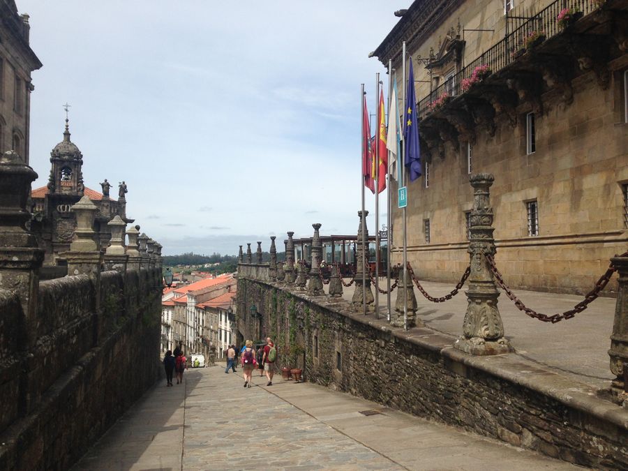 Historic street in Santiago de Compostela with stone buildings and pedestrians