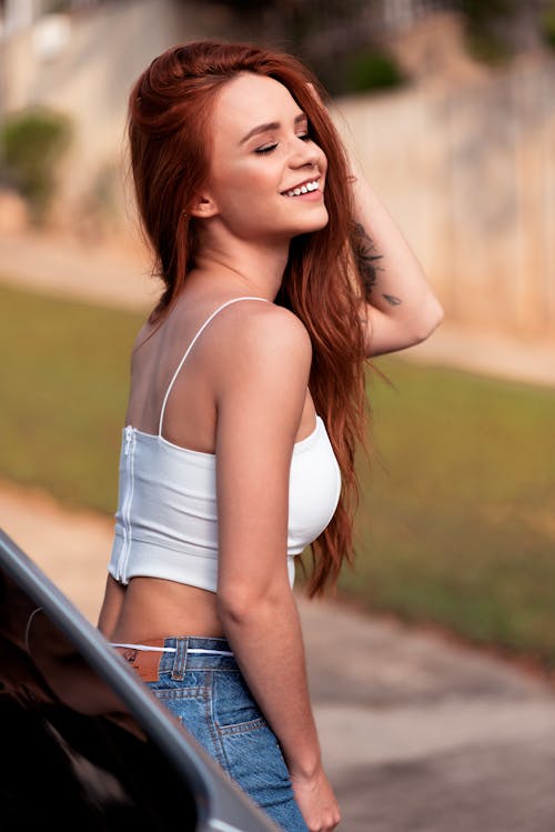 Selective Focus Photography of Woman Wearing White Crop Top Smiling