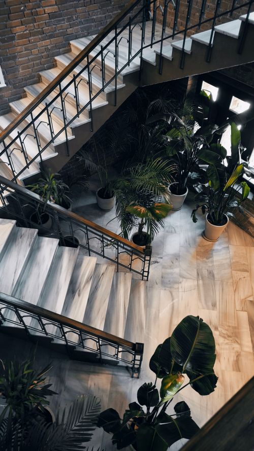 Free A beautifully designed staircase adorned with lush plants in an Istanbul interior space. Stock Photo