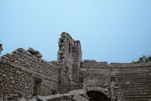 Free Stone ruins with a clear blue sky above, depicting historical architecture. Stock Photo