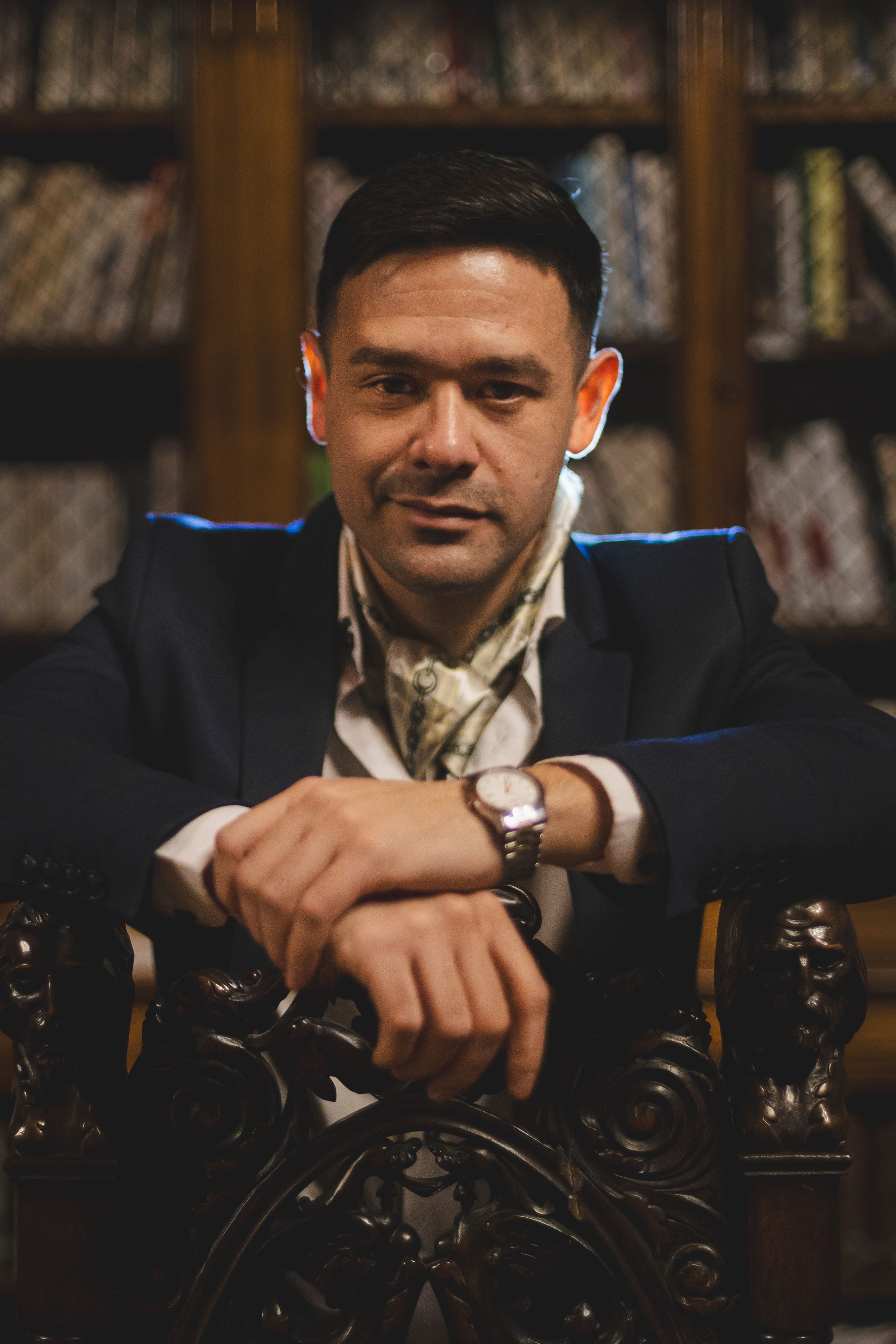 Portrait of a stylish man in a sophisticated setting with a focus on elegance.