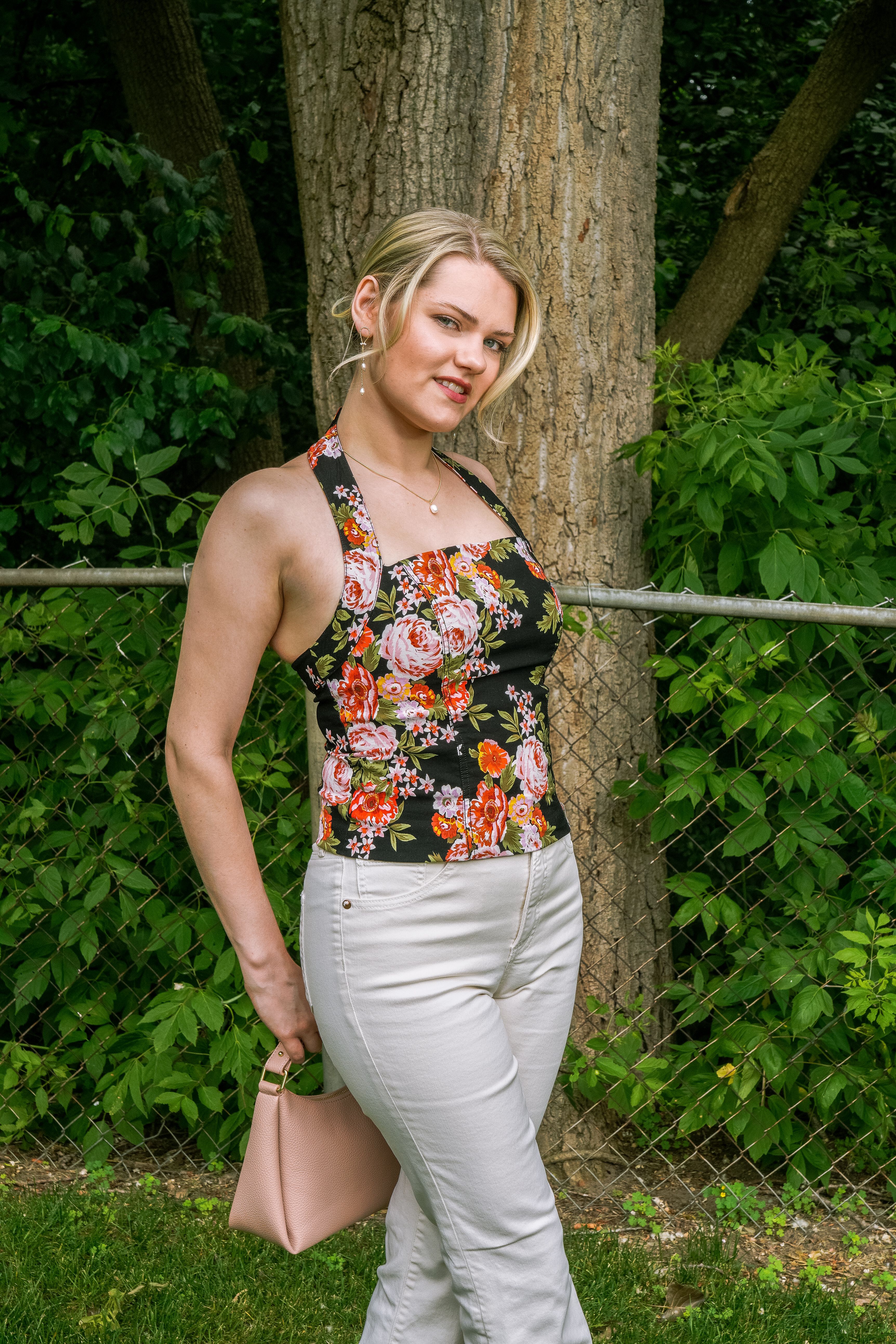 Woman in Floral Top Posing Outdoors in Summer · Free Stock Photo