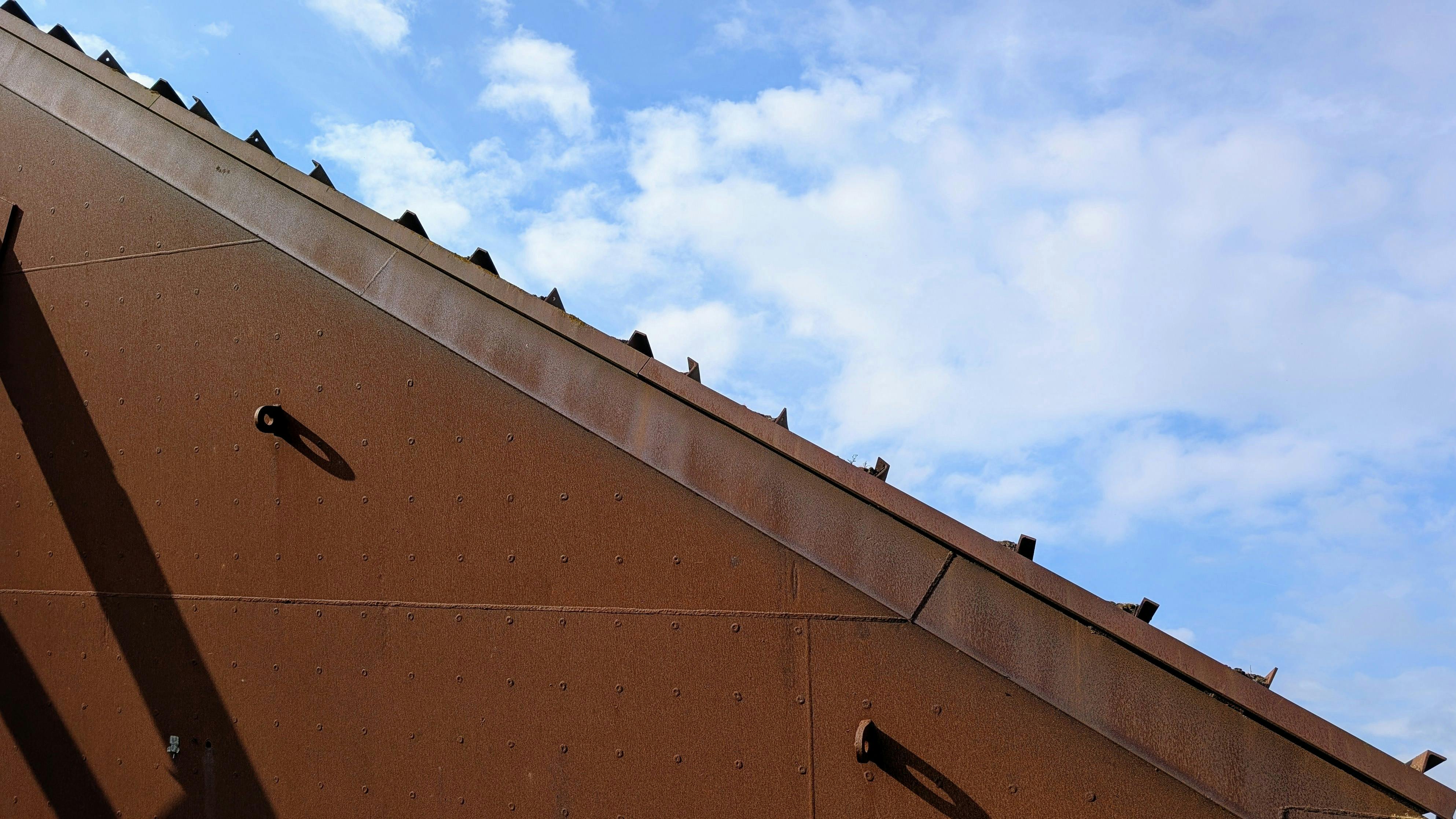 Close-up of a rusty metal roof showing corrosion texture