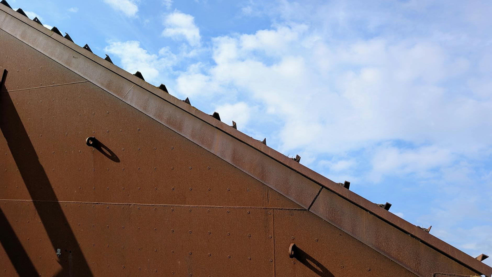 Close-up of a rusty metal roof showing corrosion texture