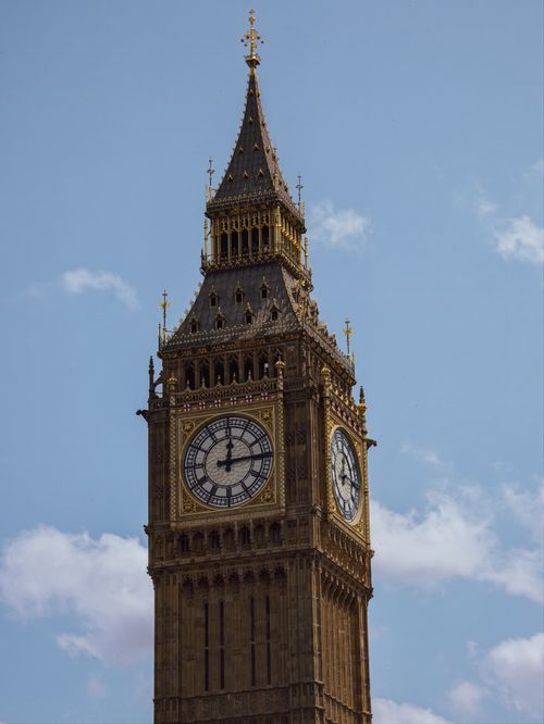 Free Close-up of the famous Big Ben tower with a clear blue sky in London, England. Stock Photo