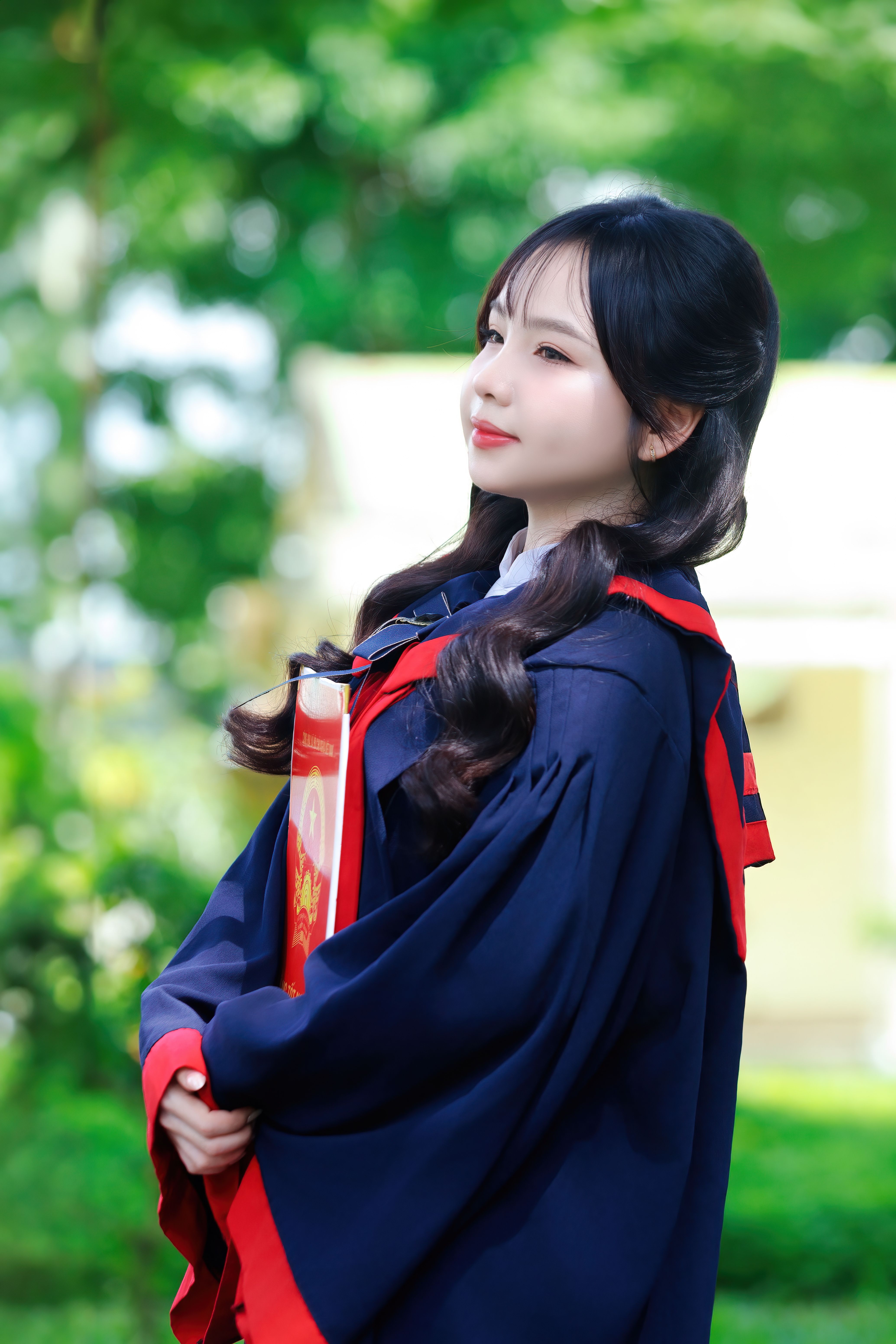 Elegant Graduate in Cap and Gown Outdoors · Free Stock Photo