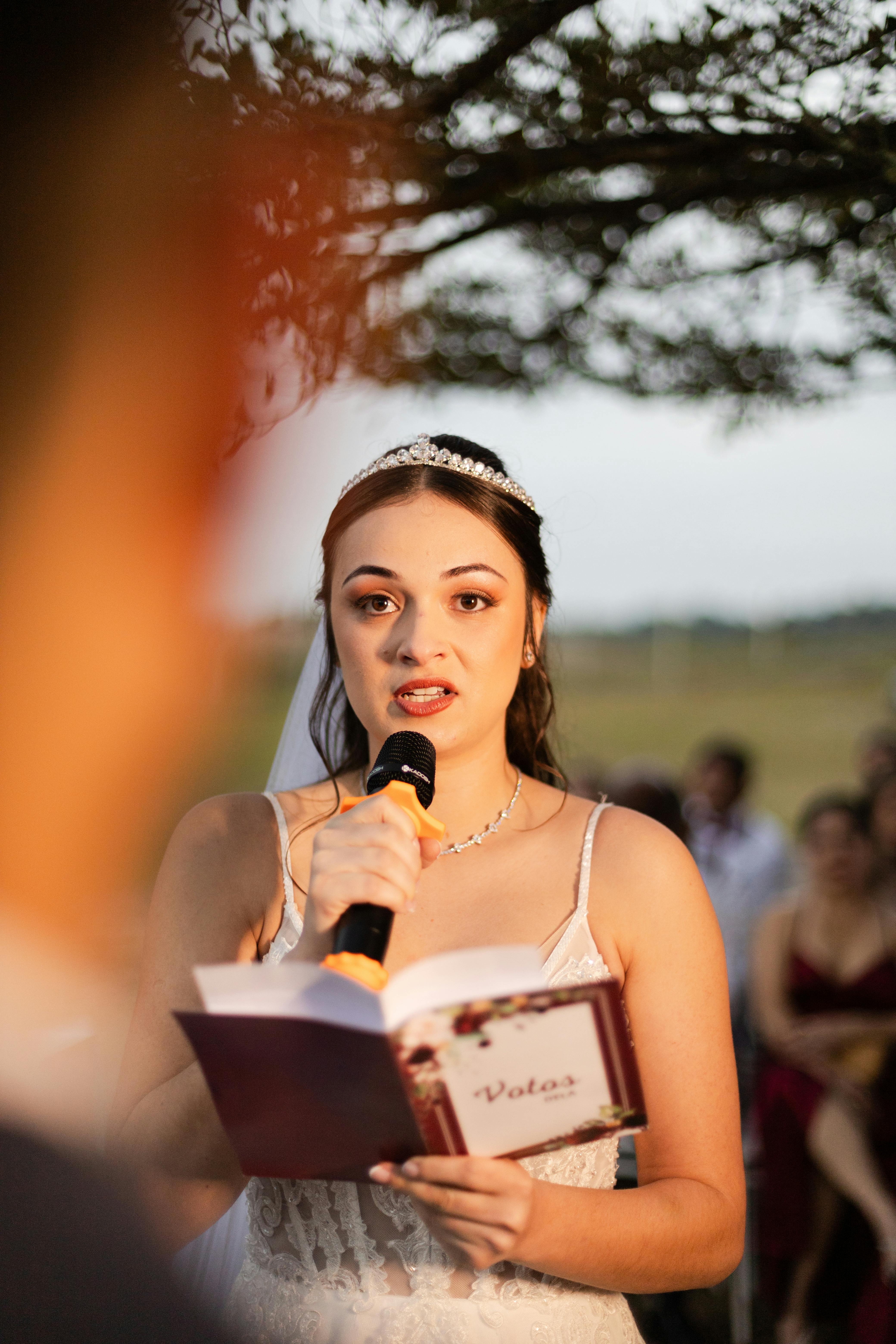 Bride reciting her vows at an outdoor wedding ceremony in São Paulo, Brazil.