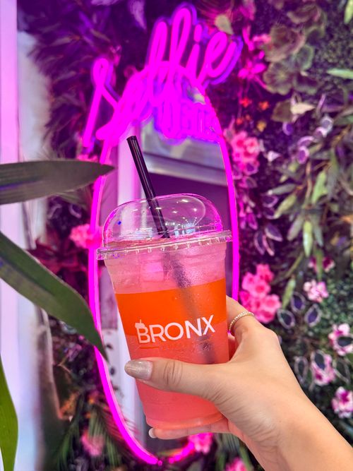 Free Vibrant pink drink in selfie booth with neon lights, Bronx theme. Stock Photo