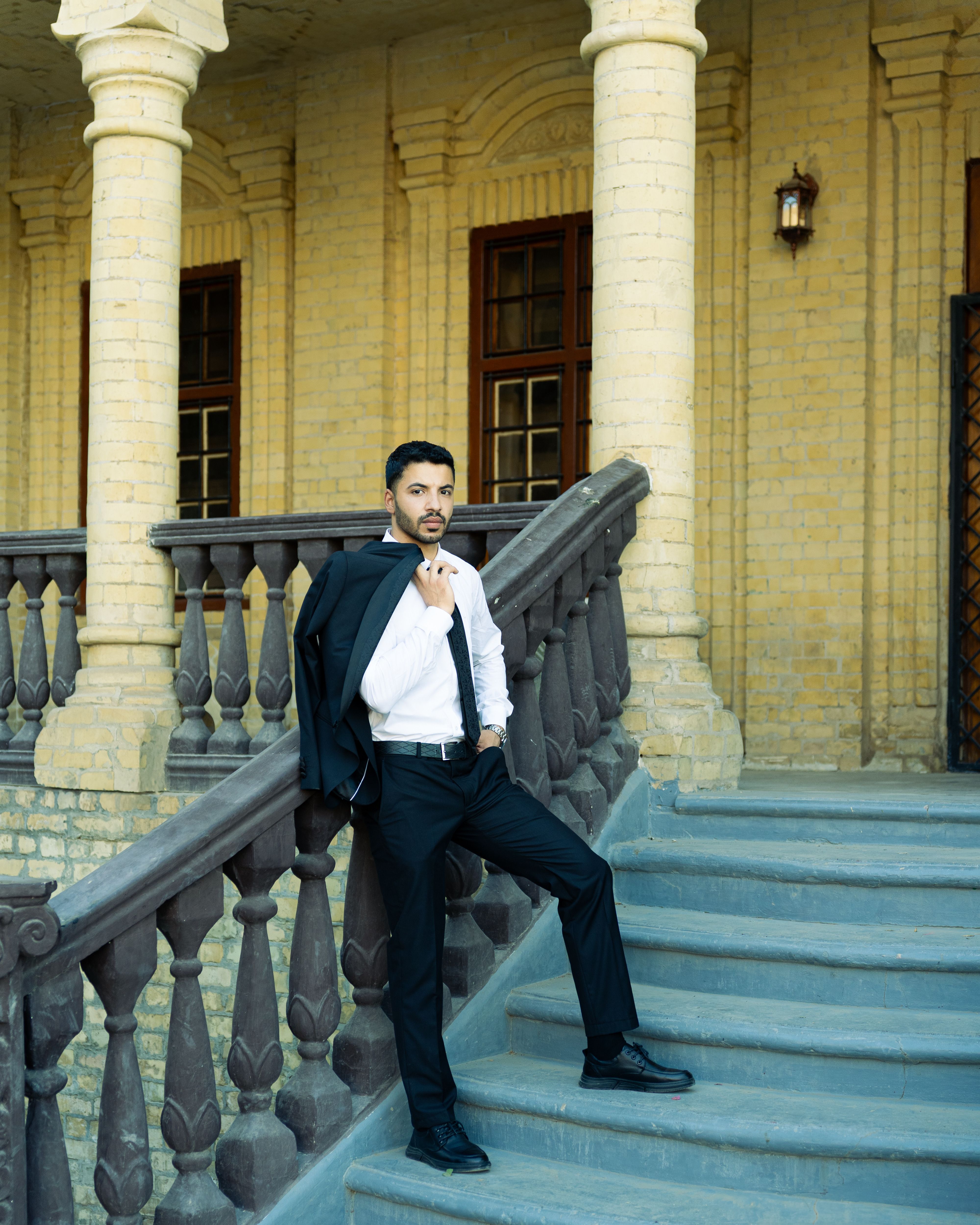 Confident Man in Suit Posing on Historic Staircase · Free Stock Photo