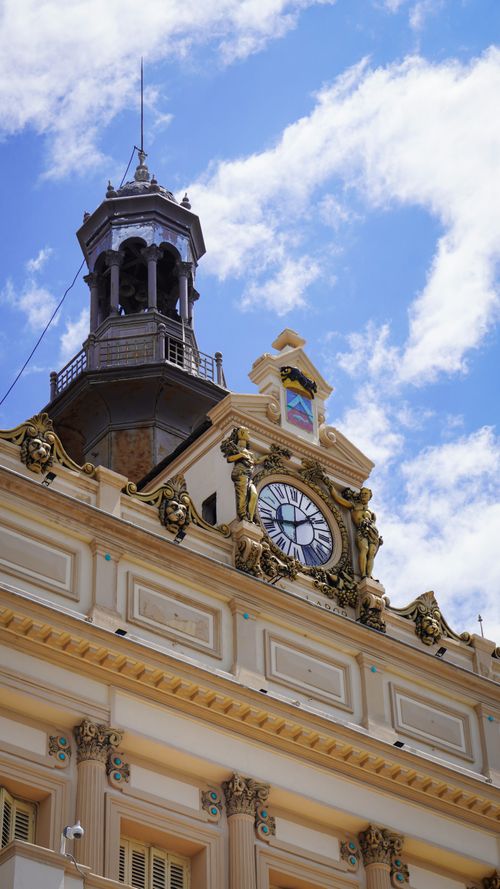 Free A detailed view of a historic clock tower in Constantine, Algeria, with ornate design under a vibrant blue sky. Stock Photo