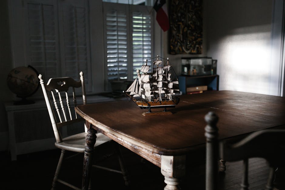 furniture shipping - A vintage dining room with a wooden table and ship model, evoking classic nautical charm.
