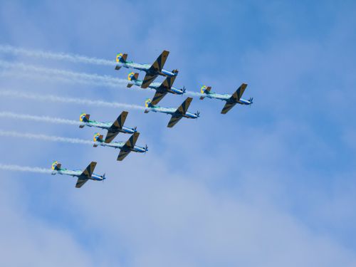 Free Stunning formation of aerobatic aircrafts performing in clear blue sky. Stock Photo