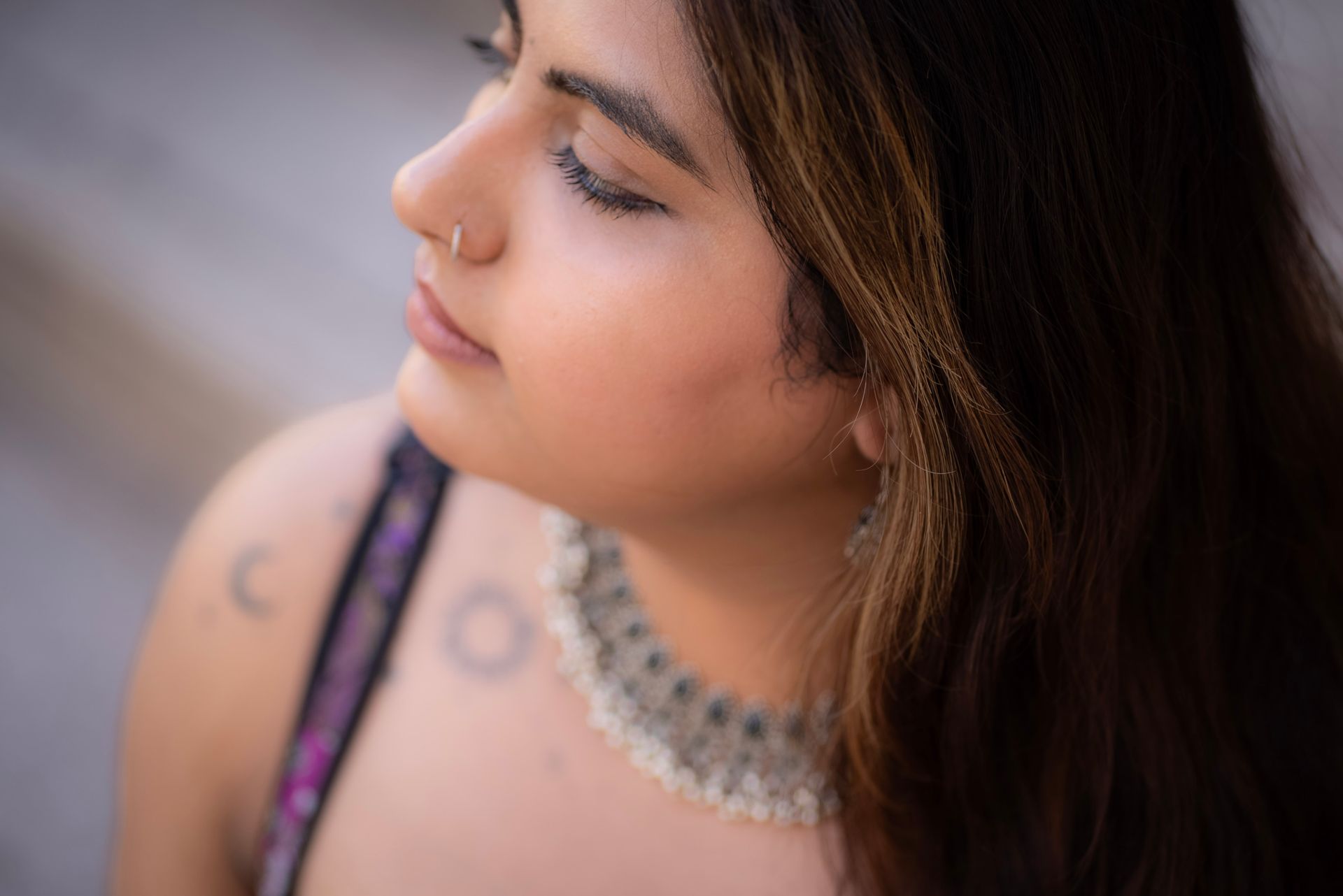Portrait of a young woman with intricate jewelry in Milan, Italy, showcasing fashion and elegance.