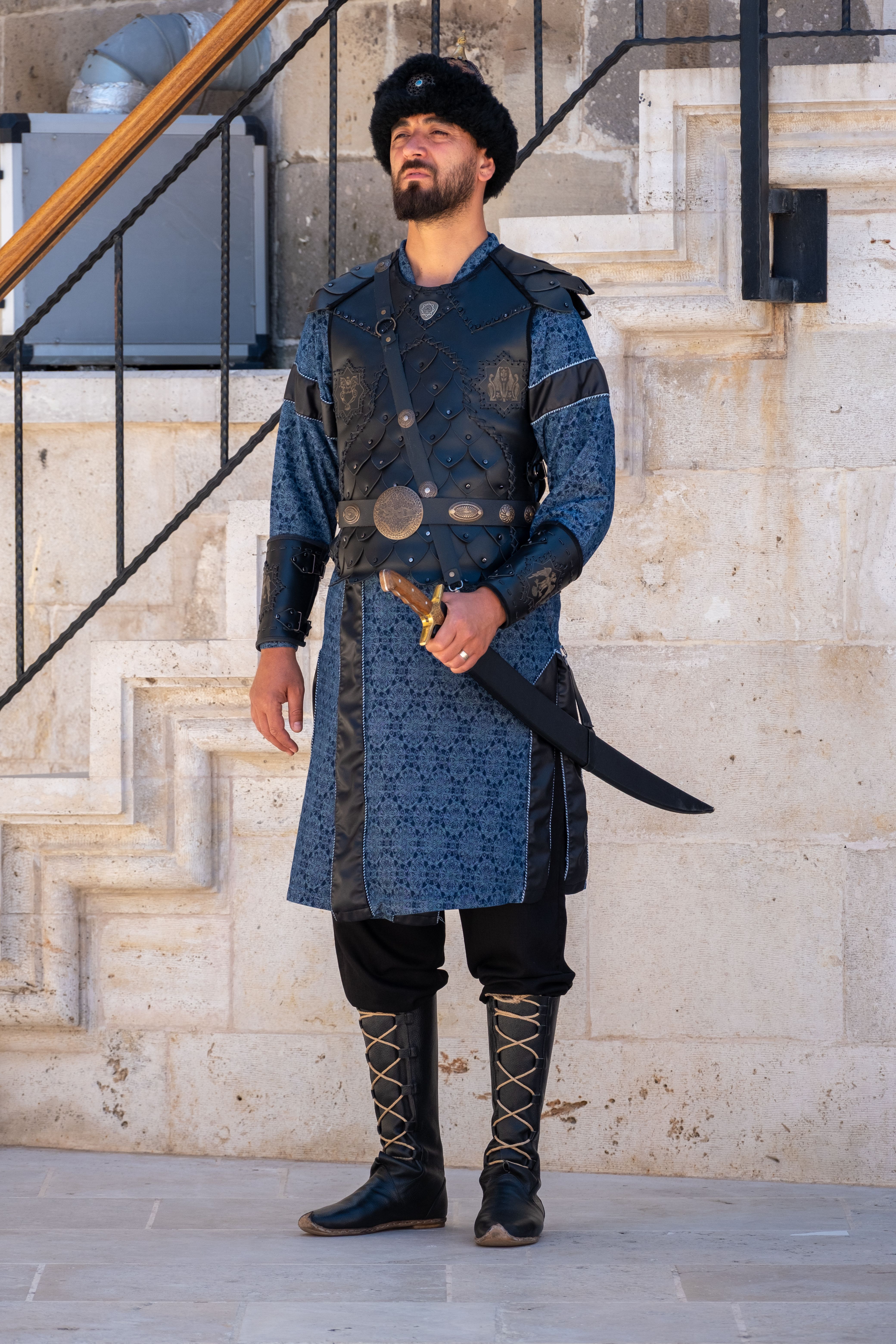 Man in medieval armor standing outdoors at Konya