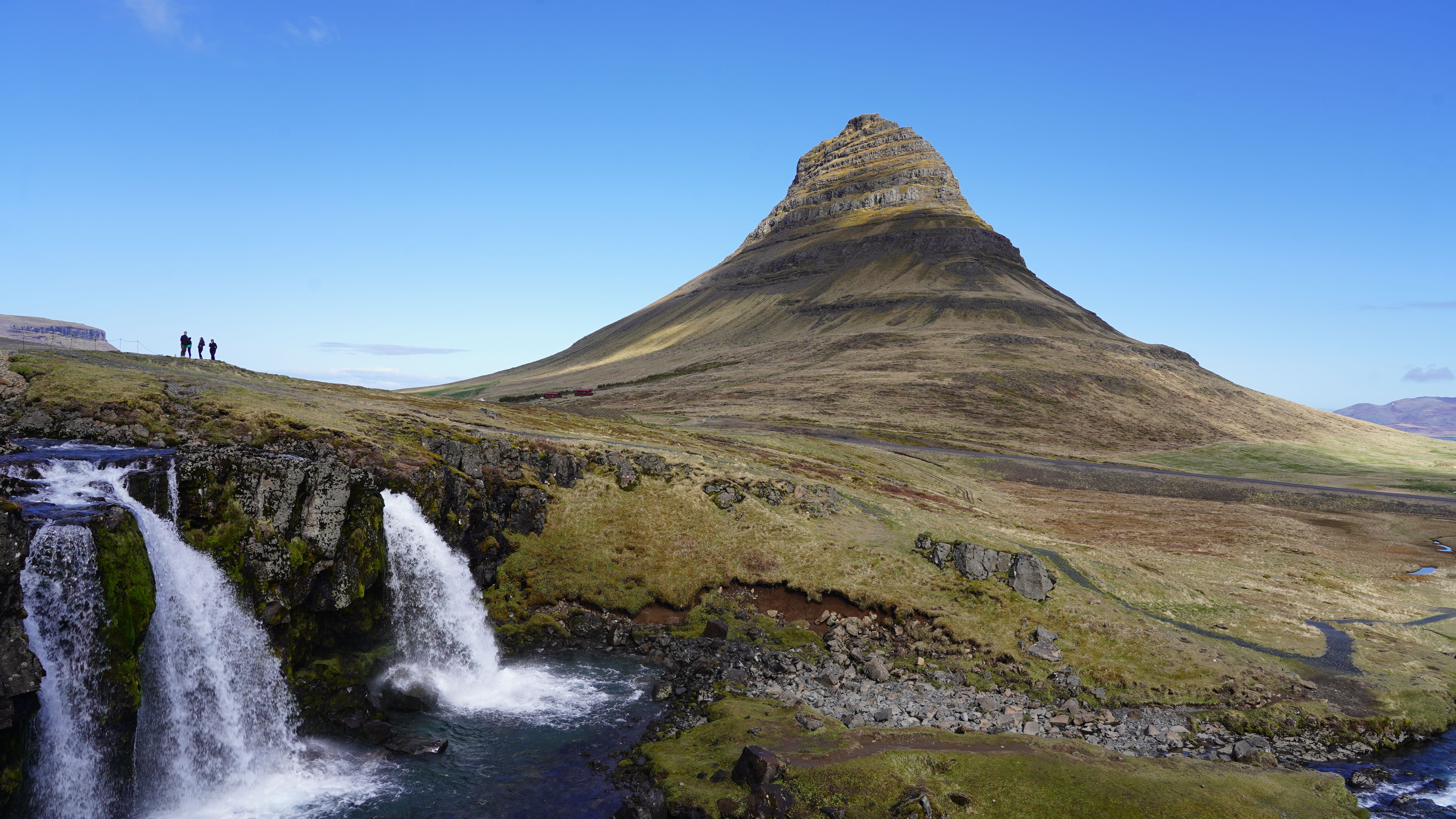 Breathtaking view of Kirkjufell Mountain and a nearby waterfall in Iceland during daytime. - Snæfellsnes