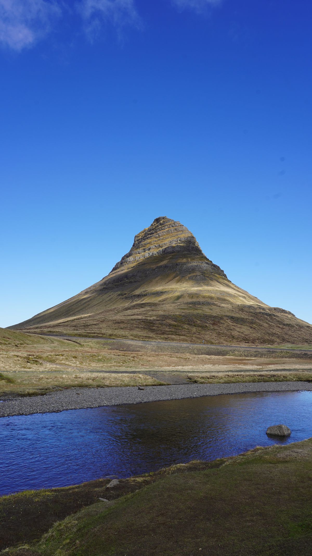Kirkjufell's cone rising above the Snaefellsnes coast