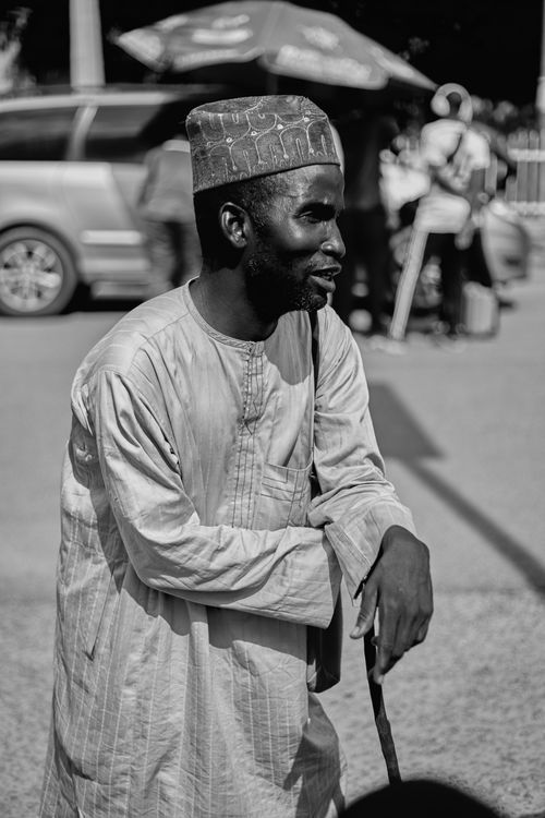 Free A striking black and white street portrait of a man in traditional attire, exuding a timeless appeal. Stock Photo