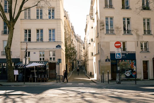 Idyllic Paris street scene featuring classic architecture and a quaint cafe.