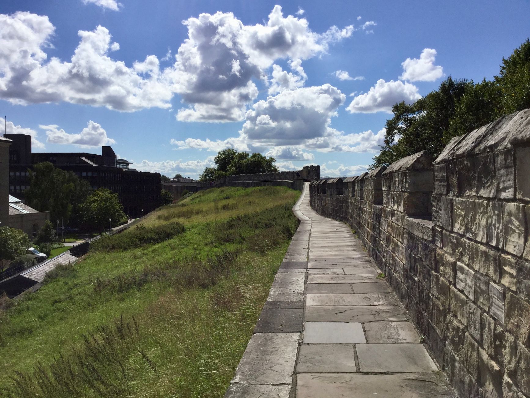 Explore the medieval stone walls of York on a sunny summer day. Perfect for history and travel enthusiasts.