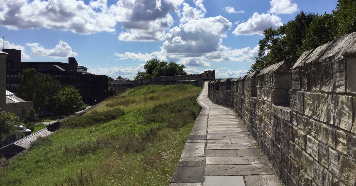 Explore the medieval stone walls of York on a sunny summer day. Perfect for history and travel enthusiasts.