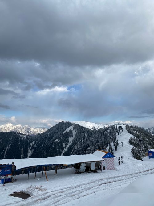 Free Winter snow scene at the picturesque Malam Jabba resort with dramatic clouds and snowy peaks. Stock Photo