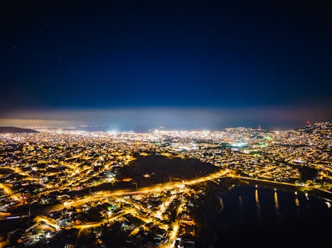 A breathtaking aerial view of a brightly lit cityscape at night with vibrant lights.