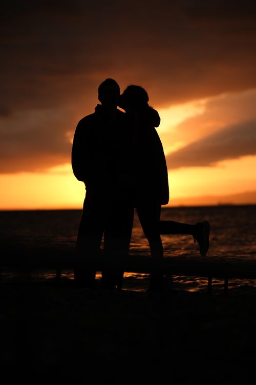 Silhouette of Couple Embracing at Sunset · Free Stock Photo