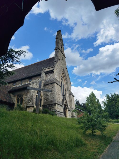 Free Beautiful historic stone church with Gothic features under a vibrant blue sky. Stock Photo
