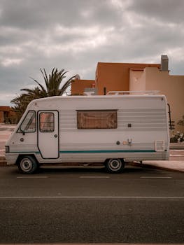 A classic camper van parked on a street in the Canary Islands, embodying retro travel vibes.