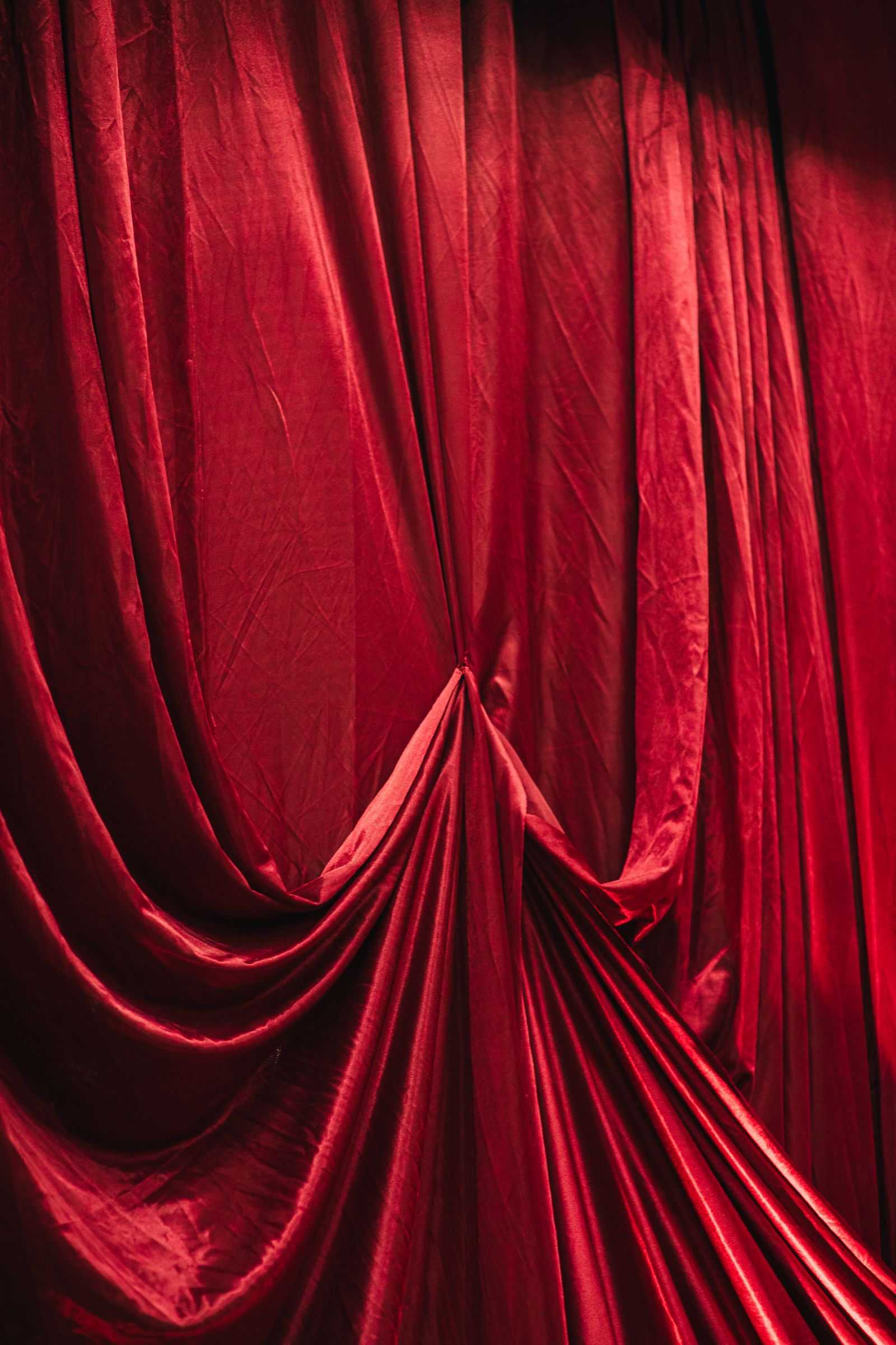 Draped red velvet curtain