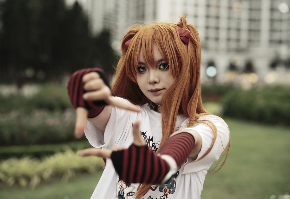 Young adult in cosplay outfit striking a pose outdoors, showcasing character portrayal.