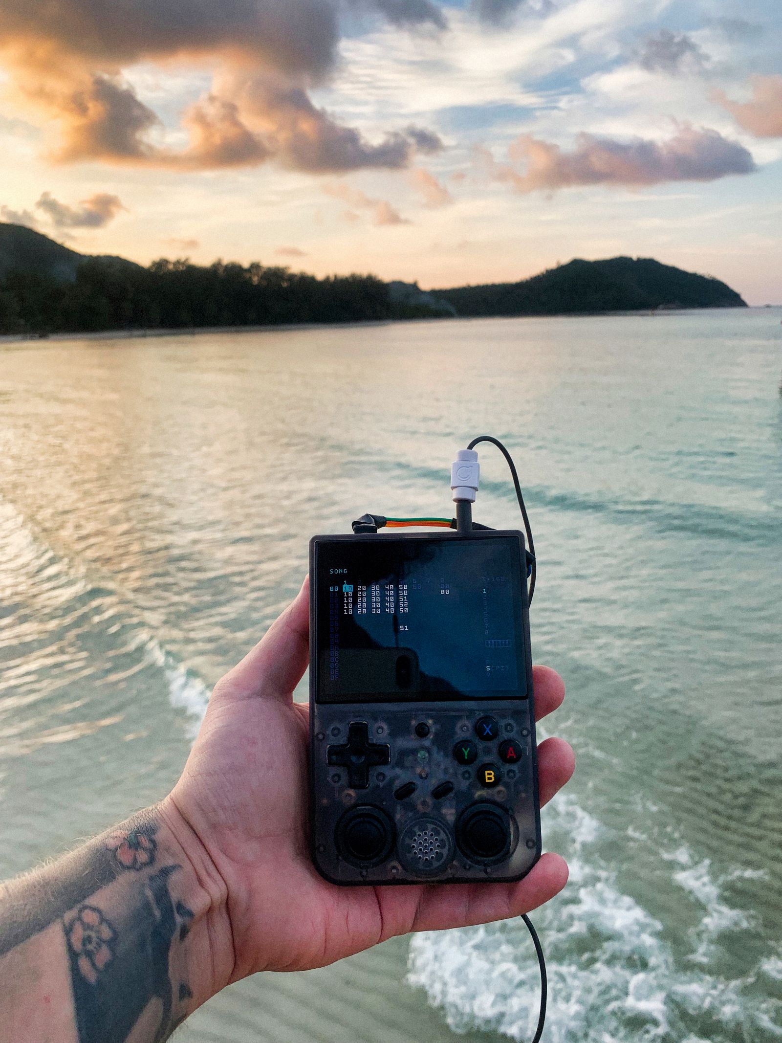 Handheld retro console being played outdoors