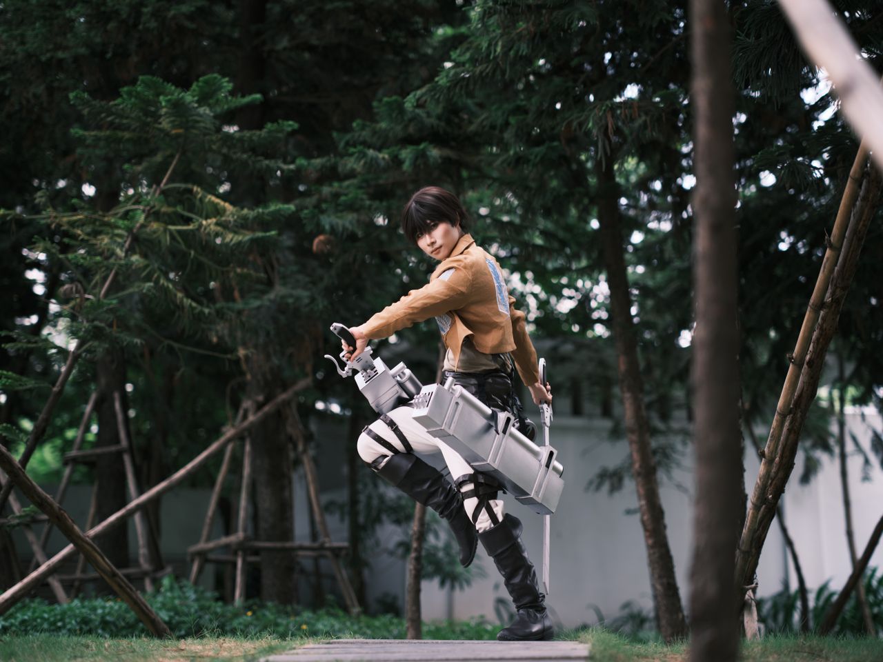 person in detailed cosplay costume posing with gear in a lush forest s