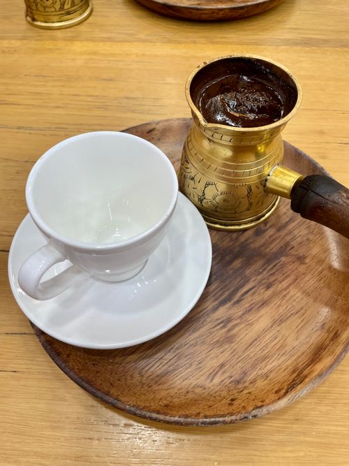 Free Authentic Turkish coffee served with a brass cezve and white cup on a wooden tray. Stock Photo