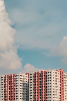 Cloudy blue sky over modern high-rise apartments in Dhaka, Bangladesh.