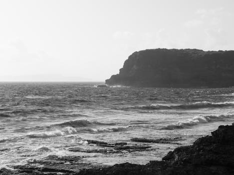 Explore the dramatic cliffside views of Le Moule, Guadeloupe's stunning coastline in black and white.