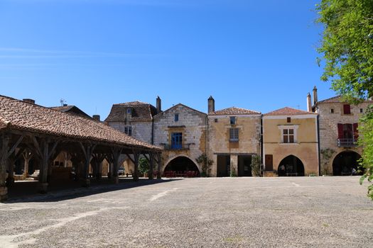 Charming medieval architecture in a peaceful European plaza on a sunny day.