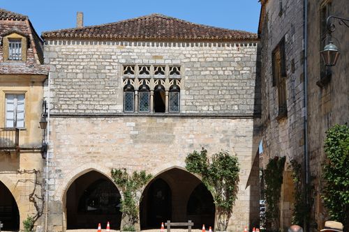Free A medieval building showcases gothic arches and stone architecture under a bright sky. Stock Photo