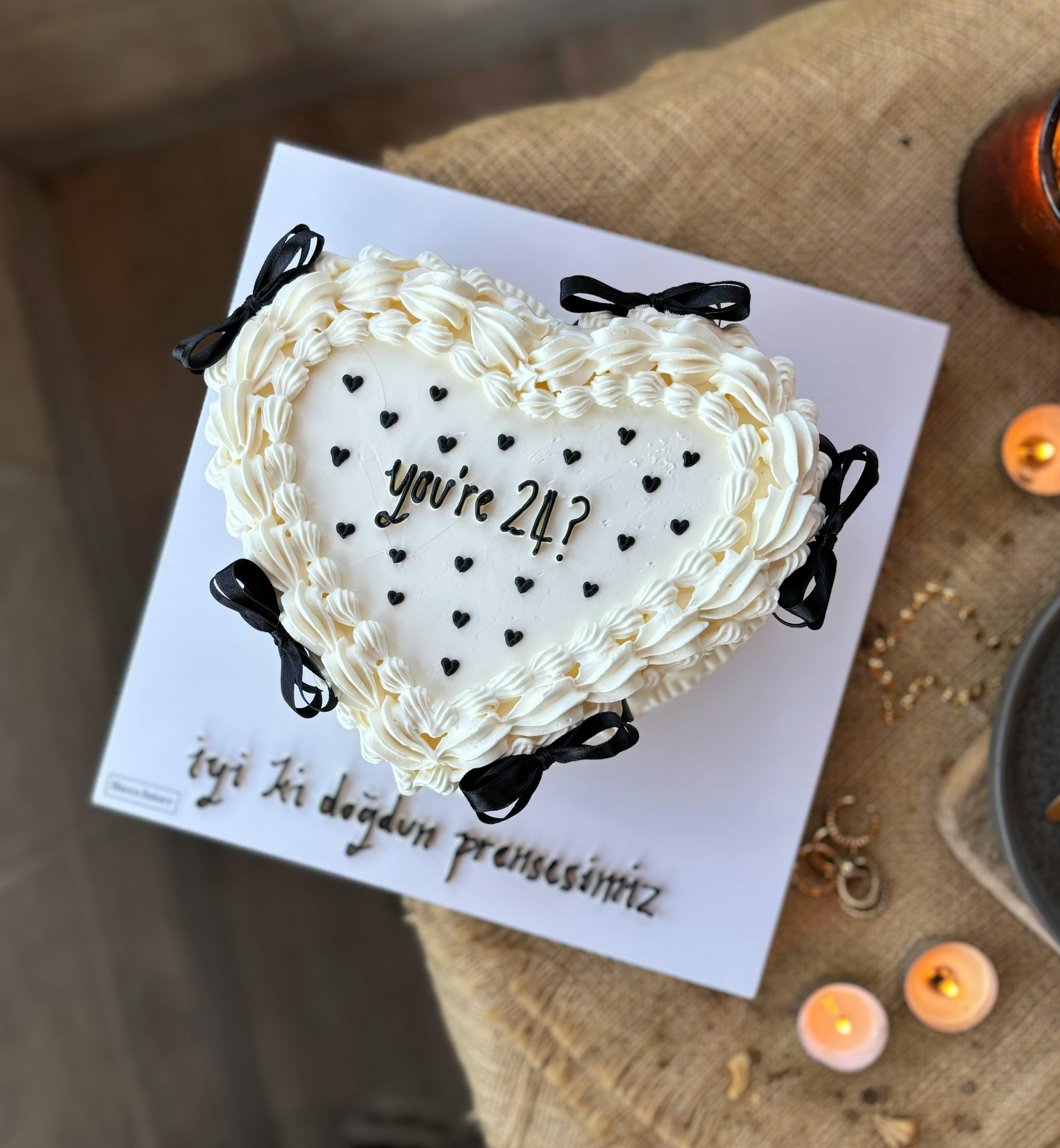 Heart-shaped cake with 'you're 24?' text, perfect for birthdays.