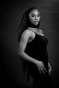 Black and white portrait of a young woman in a stylish pose.