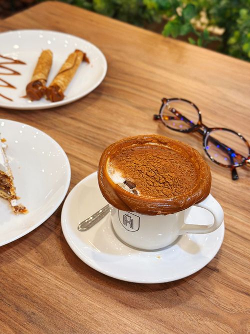 Free Delightful coffee with pastries served on a wooden table at a café in Palmas, Brazil. Stock Photo