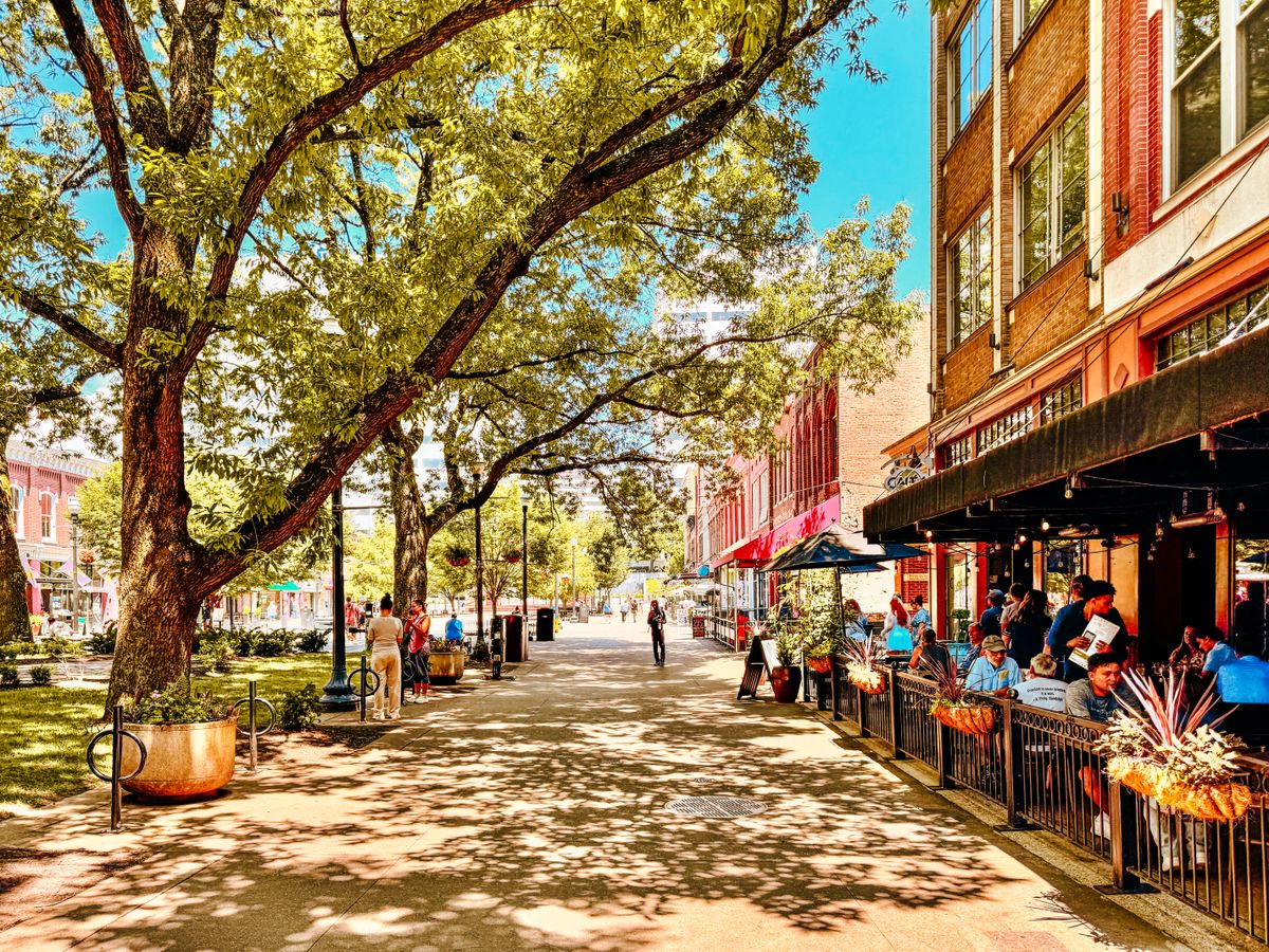 Bustling street with shops, restaurants, and pedestrians
