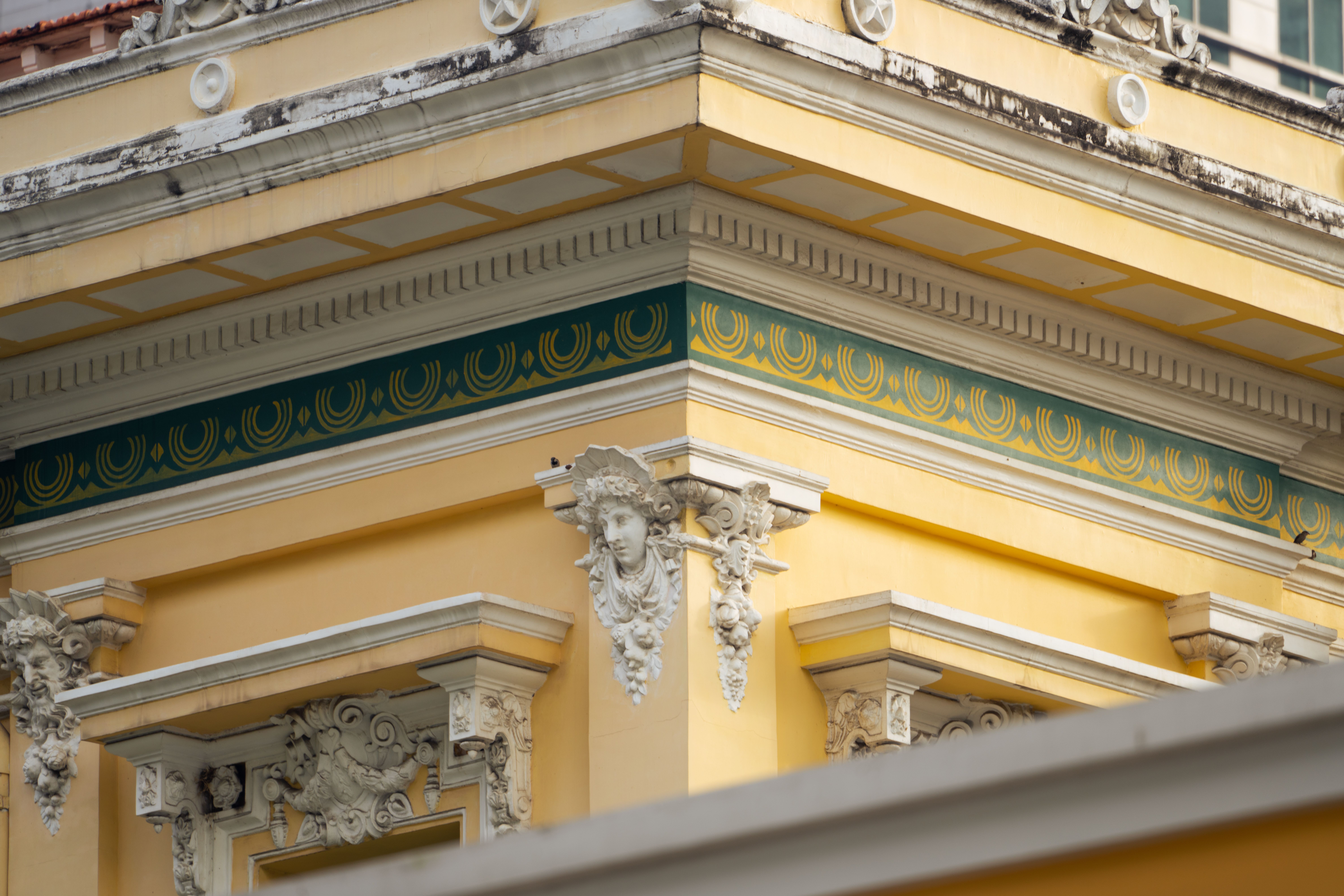 Architectural Detail of Ornate Yellow Building Facade · Free Stock Photo