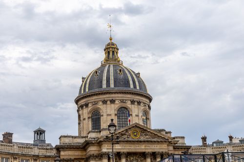 Free Classical architecture of the Institut de France in Paris under a cloudy sky. Stock Photo
