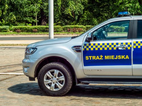 Free A municipal police vehicle parked on a cobblestone street during the day. Stock Photo